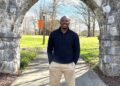 Chuck Sutton stands in front of the Tusculum Arch.
