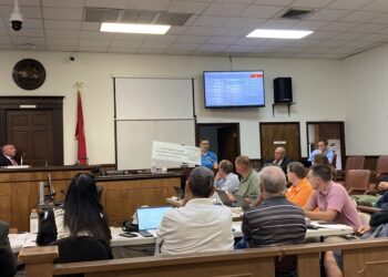 Marie Marsh speaking in favor of Constables and showing check from community.