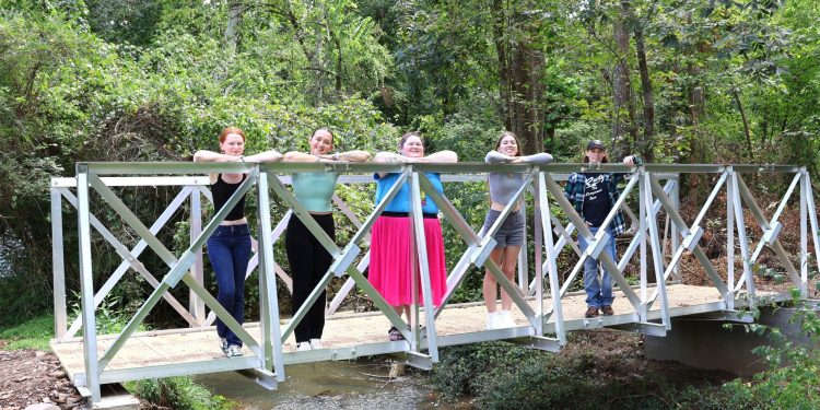 Tusculum University students stand on the new bridge. They are, left to right, Sage Clapp, Kyra Klouzek, Mirissa Walters, AnnaLee Simpson and Rusty Thompson