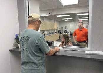Deputy Trustee Rachael Chandley and Greene County Trustee Nathan Holt assist a customer at the new office on April 13, 2026.