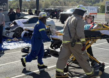 A simulated "victim" is taken to an ambulance on a gurney during the annual Prom Promise event Thursday morning, which showed local high schoolers the dangers of driving impaired.