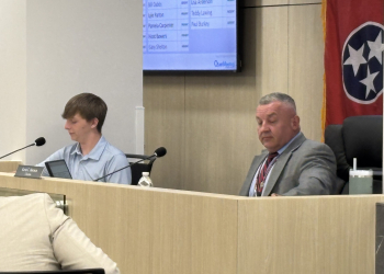 Bentley Parton , along side Mayor Kevin Morrison at the Monday meeting of the County Commission.