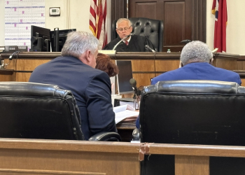 Judge John F. Dugger with the prosecution team looking on, charging the jury this morning prior to them beginning deliberations.