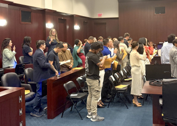 Those becoming citizens take an oath of allegiance to America during a naturalization ceremony held Wednesday at the Federal Courthouse.