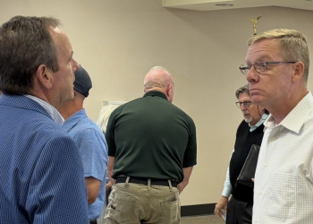 Mayor Cal Doty speaks with new Airport Authority Board member John Curan following the Tuesday meeting.