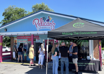 Under the GEA Connect tent, Broadband Business Development Director Drew Hall discuss options with customers while other visitors enjoy free snow cones given to the first 150 visiting during the event.