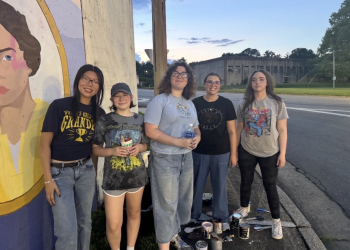 These Greeneville High students, members of the National Art Honor Society, showed up to repair the mural after vandals damaged it the night before
