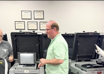 (L-R) Bill Edmonds, Charles Johnson, Matthew Hensley, Charlena Kendrick Dean and Latasha Keller reviewing the machines Tuesday.