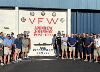 Former USS Greeneville sailors stand in front of a mural of the submarine at Greeneville's local VFW Post on Friday morning. The new mural was unveiled during a breakfast held for the sailors at the local post on Friday morning.