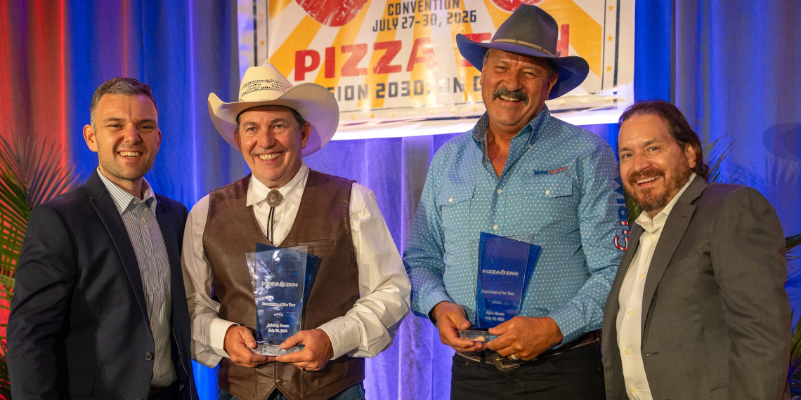 Kyle Moore, second from left, and Johnny Jones, second from right, pose for a photo after being honored as the company's "Franchisees of the Year" for their Greeneville location.