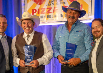 Kyle Moore, second from left, and Johnny Jones, second from right, pose for a photo after being honored as the company's "Franchisees of the Year" for their Greeneville location.