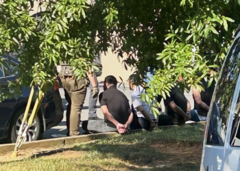 Some of those arrested and in handcuffs Wednesday surrounded by law enforcement (Radio Greeneville News photo)