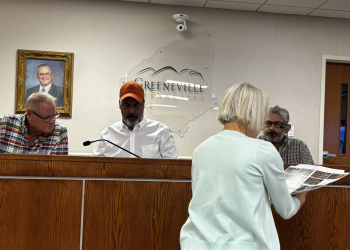 Property owner Cheryl Richards shares samples of roofing planned for her home with Historic Zoning commission members.