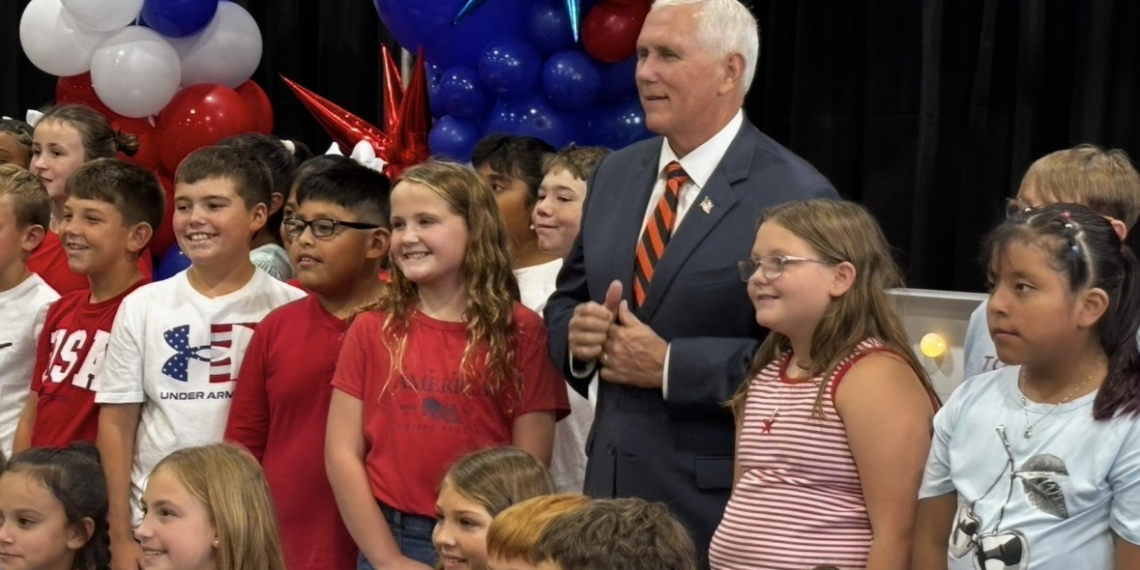 Mike Pence gathers for a photo opp with Doak 4th grade chorus members who sang during the luncheon