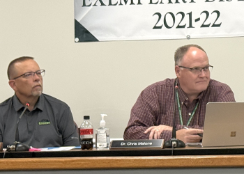 7th District School Board member Rick Tipton, left, and Greene County Director of Schools Dr. Chris Malone, right, listen during Thursday's Greene County School Board meeting. Tipton remained chairman of the board during its annual reorganization.
