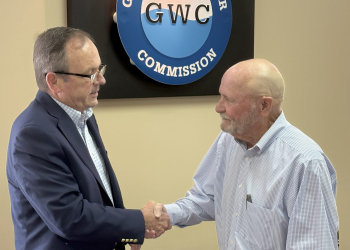 Greeneville Water Commissioner Johnny Honeycutt, right, shakes hands with Greeneville Mayor Cal Doty, left, after being sworn in for a another term on the Water Commission board on Tuesday morning.