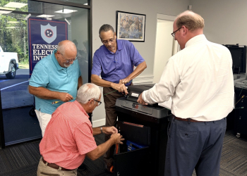 (L-R) Donnie Bell, Charles Johnson, Bill Edmonds and Matthew Hensley examining and certifying machines Wednesday