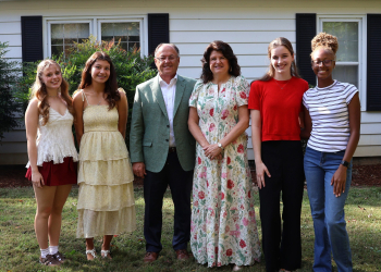 Jeff and Lisa Idell pose with women who reside in the house.