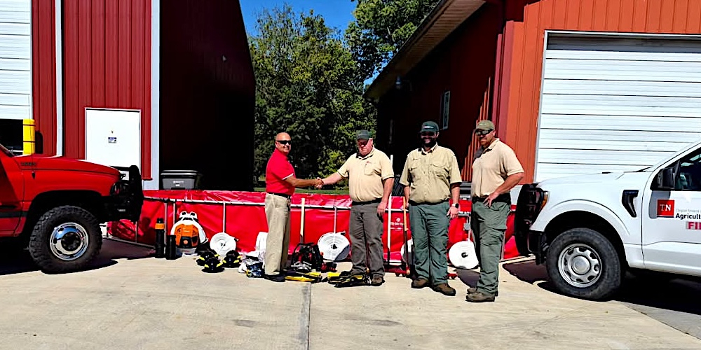 Tusculum VFD Chief Marty Shelton accepts equipment from Tennessee Division of Forestry officials Brad Ball, Jessie Smith, and Alex Bremner.
