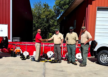 Tusculum VFD Chief Marty Shelton accepts equipment from Tennessee Division of Forestry officials Brad Ball, Jessie Smith, and Alex Bremner.